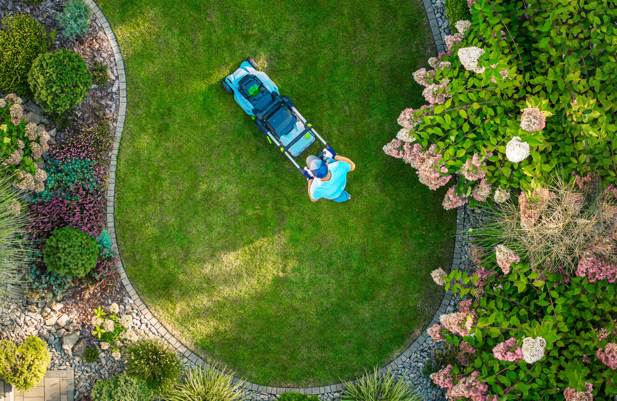 a person mowing a circular lawn surrounded by colo 2024 09 06 19 57 12 utc scaled