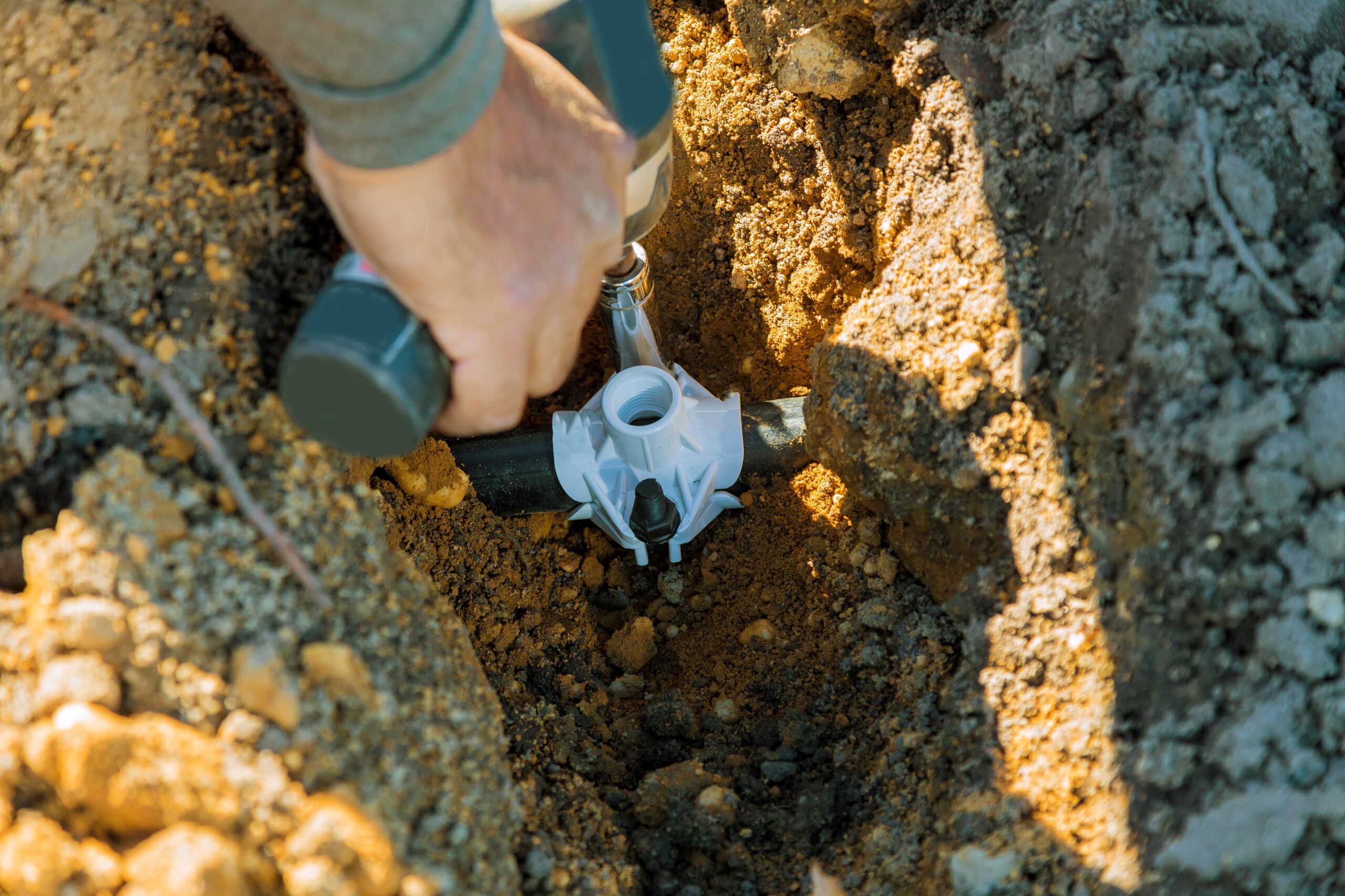 Tools and parts to install a hose for irrigation laying in garden on ground